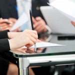 Business - meeting in an office, lawyers or attorneys discussing a document or contract agreement